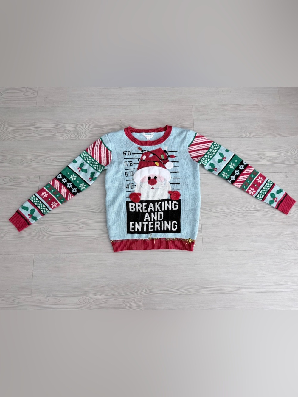 No Boundaries Light Blue Santa Mugshot Holiday Sweater with Red & Green Accents
